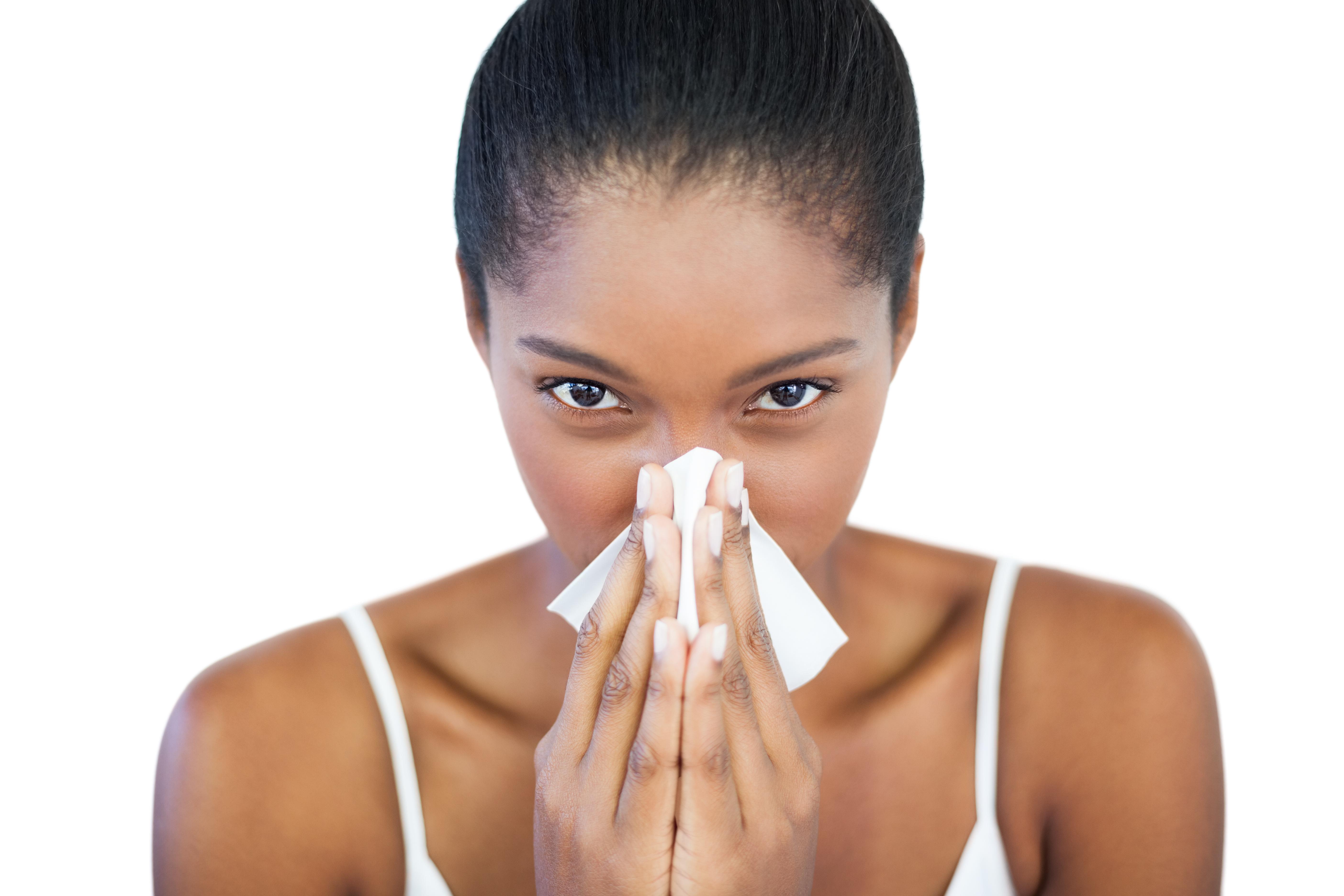 Serious woman has a cold on white background