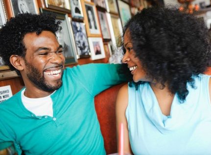 Smiling couple sitting in diner booth