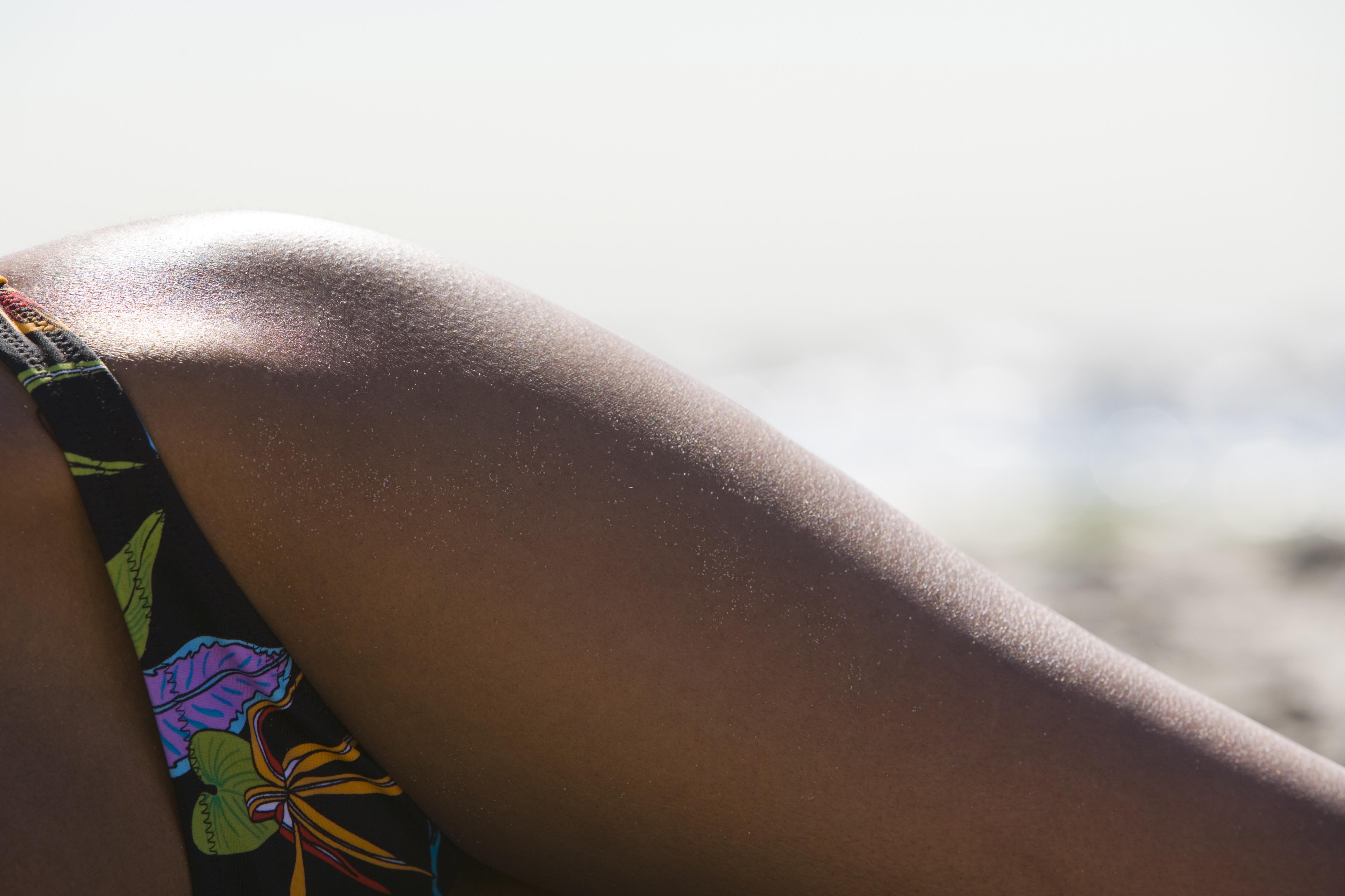 Close-up of a young woman sunbathing on the beach