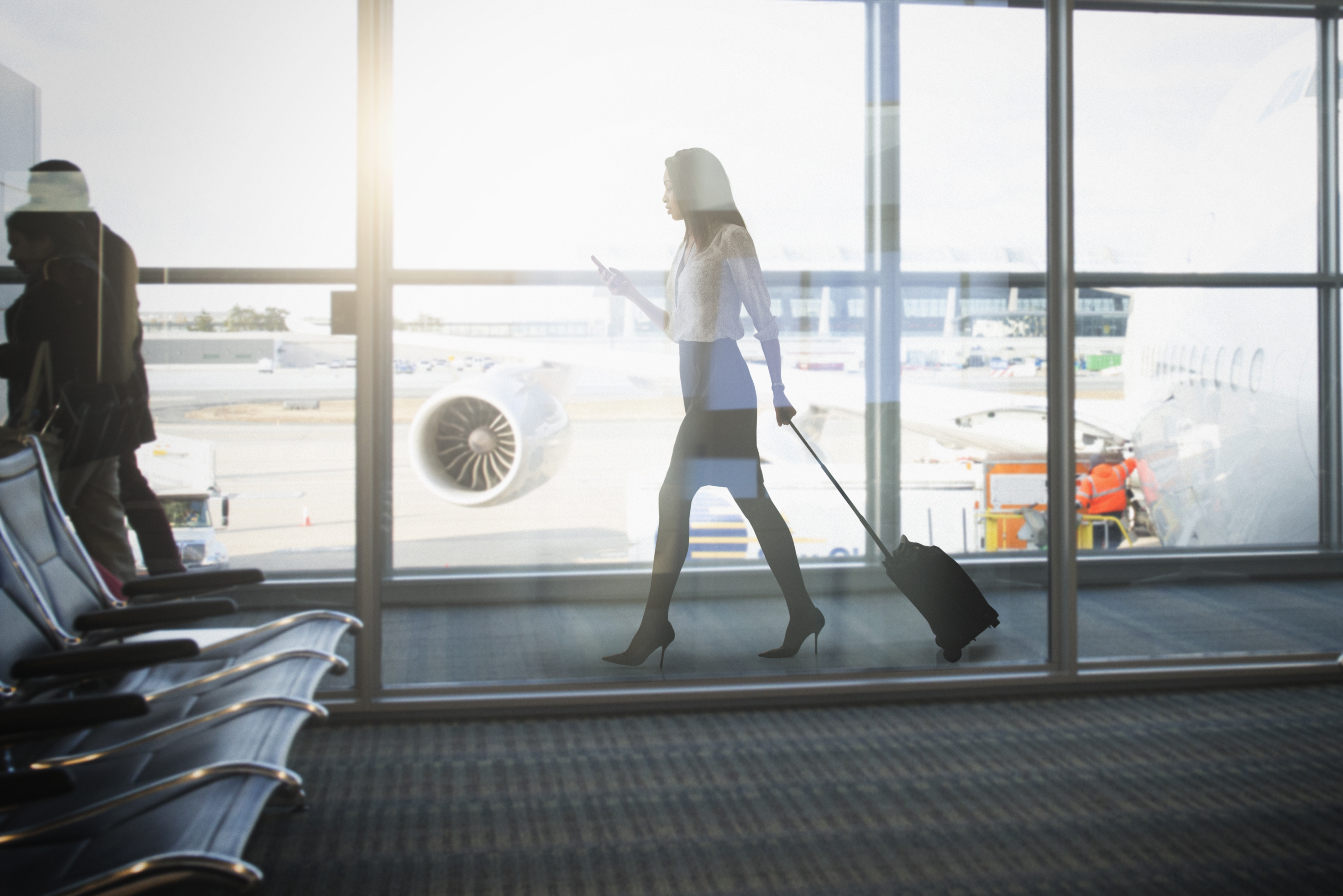 Mixed race businesswoman walking in airport