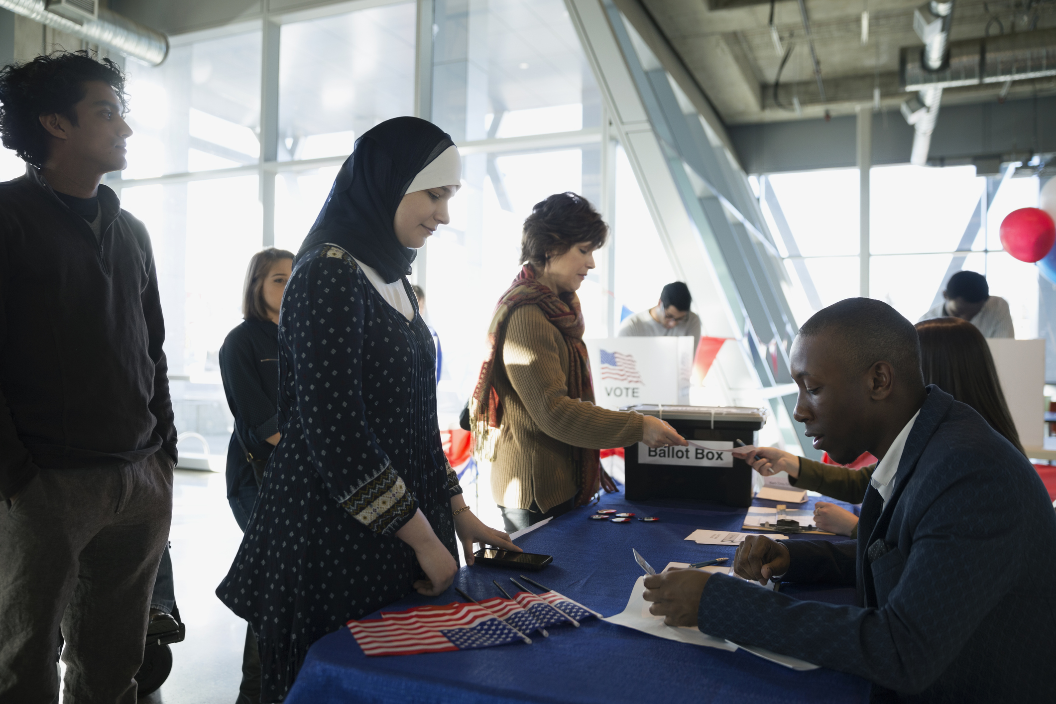 Volunteers checking voters in at polling place