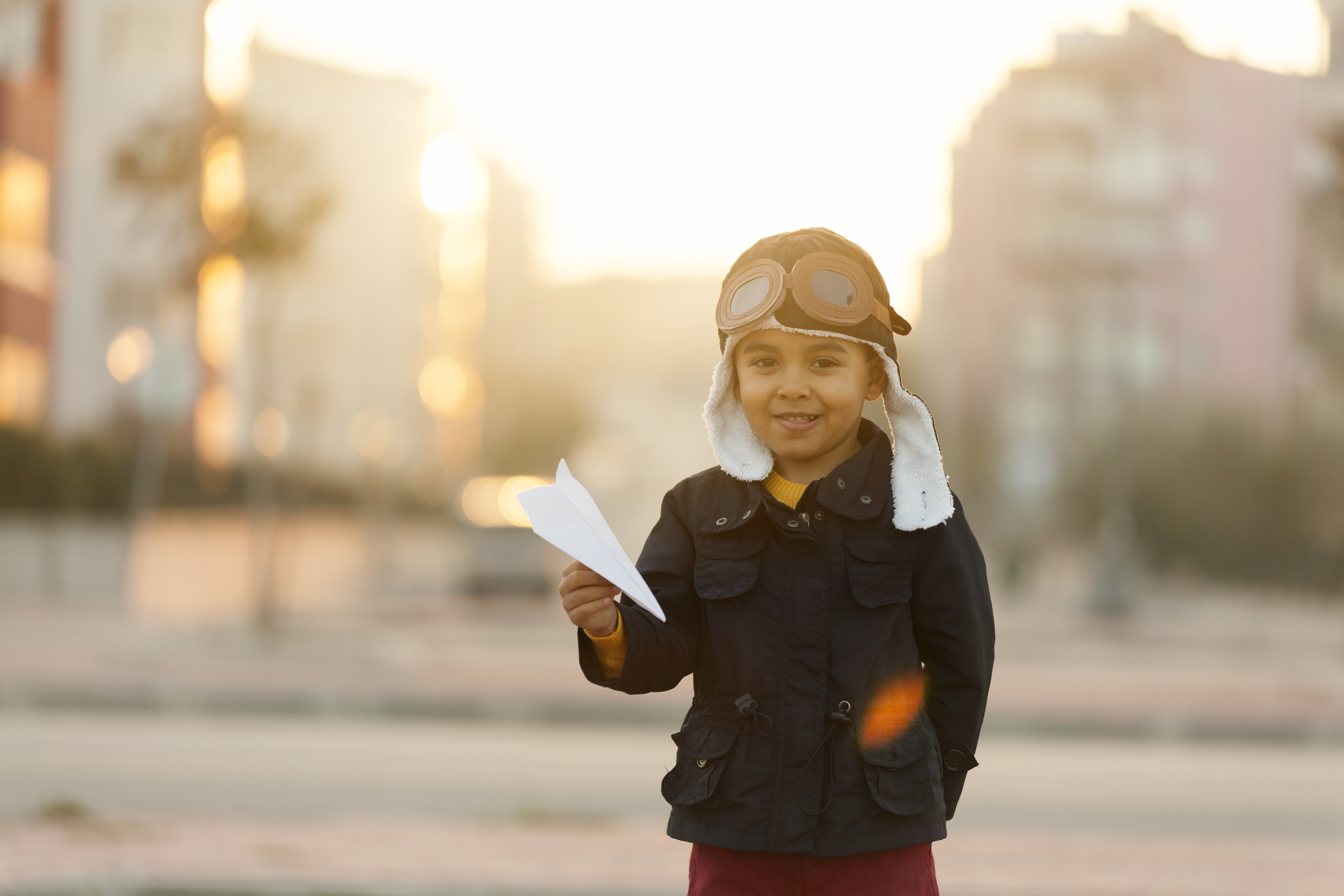 Small boy playing with paper plane