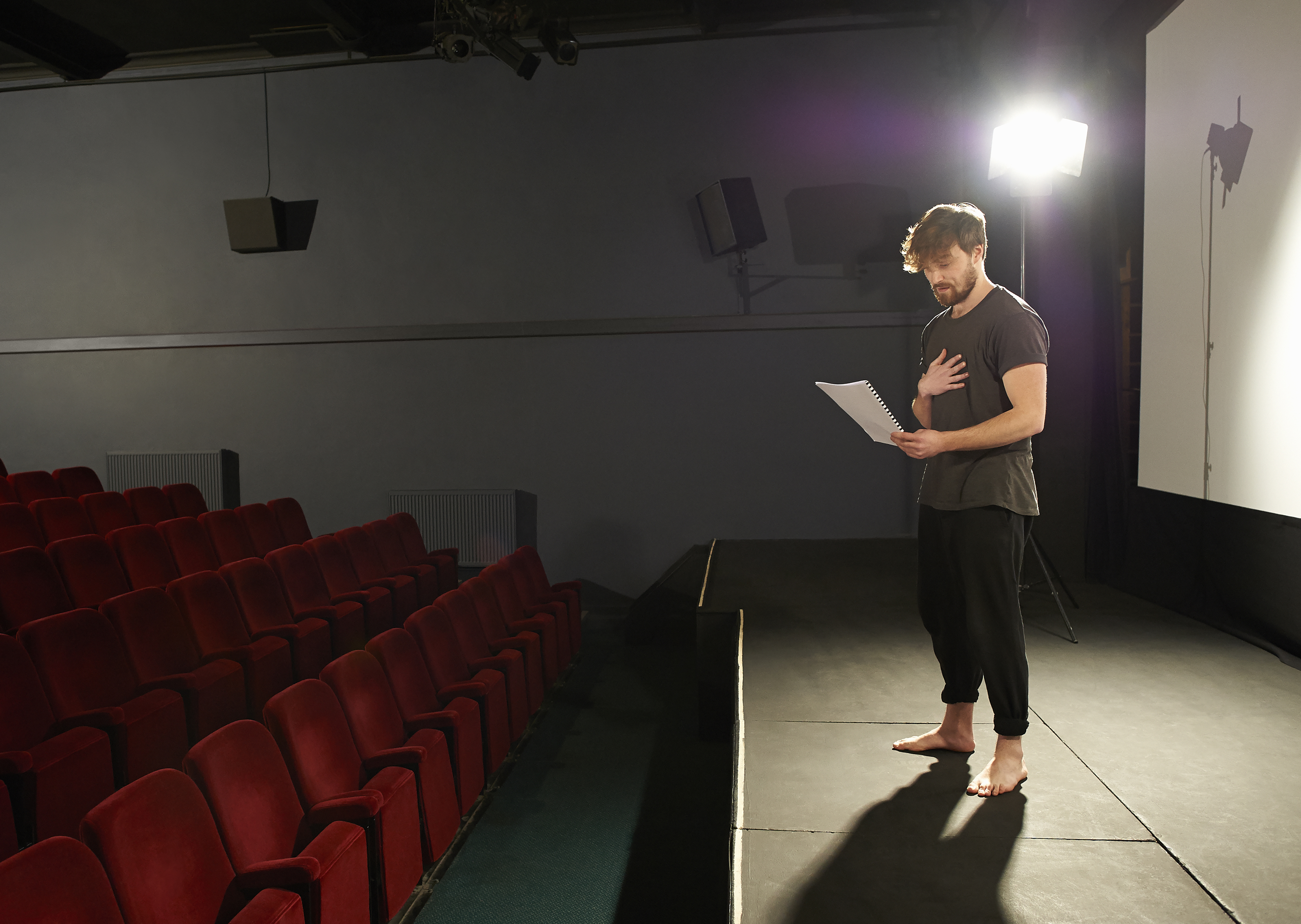 Actor rehearsing his lines on stage.