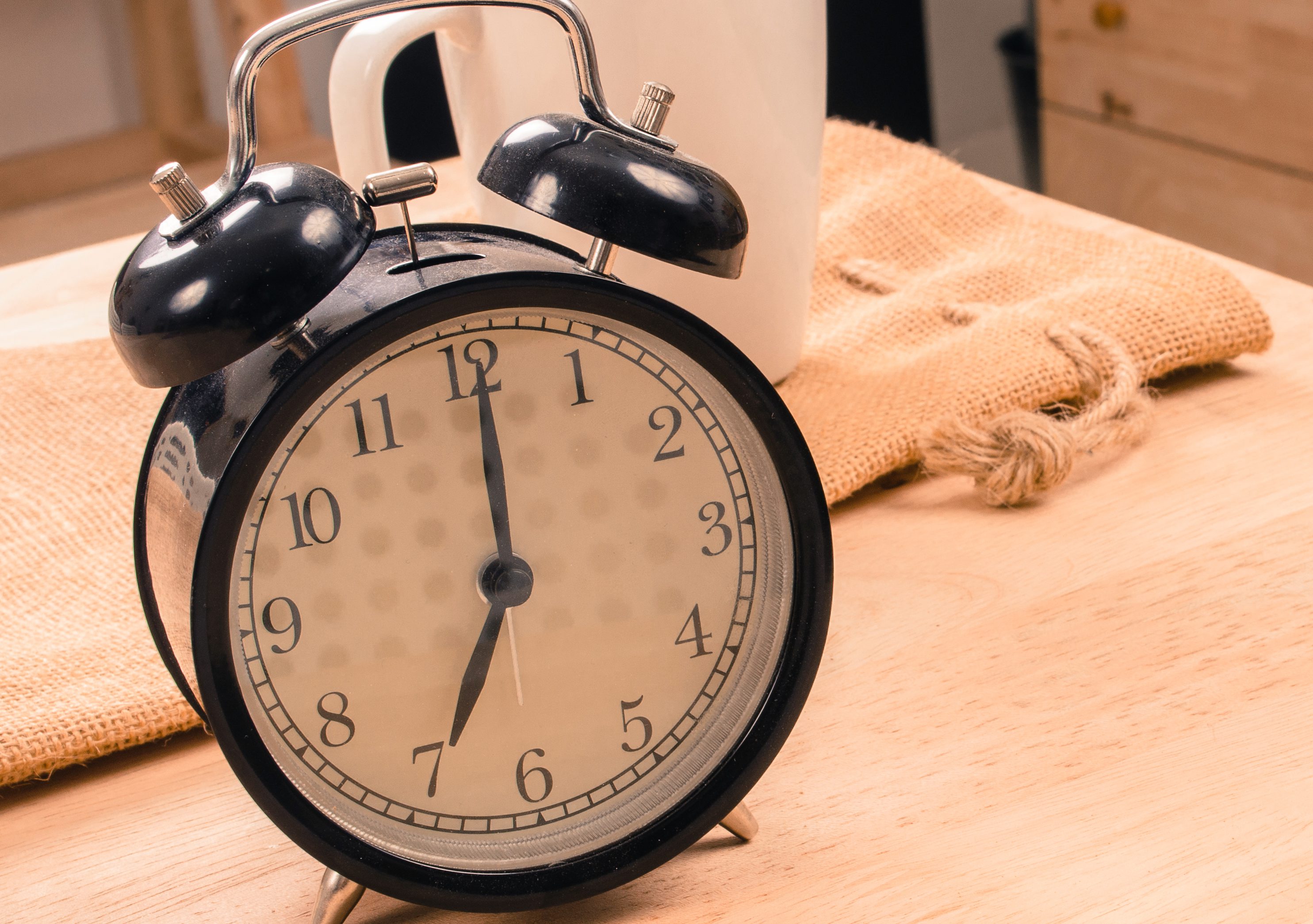 Close-Up Of Alarm Clock On Table At Home