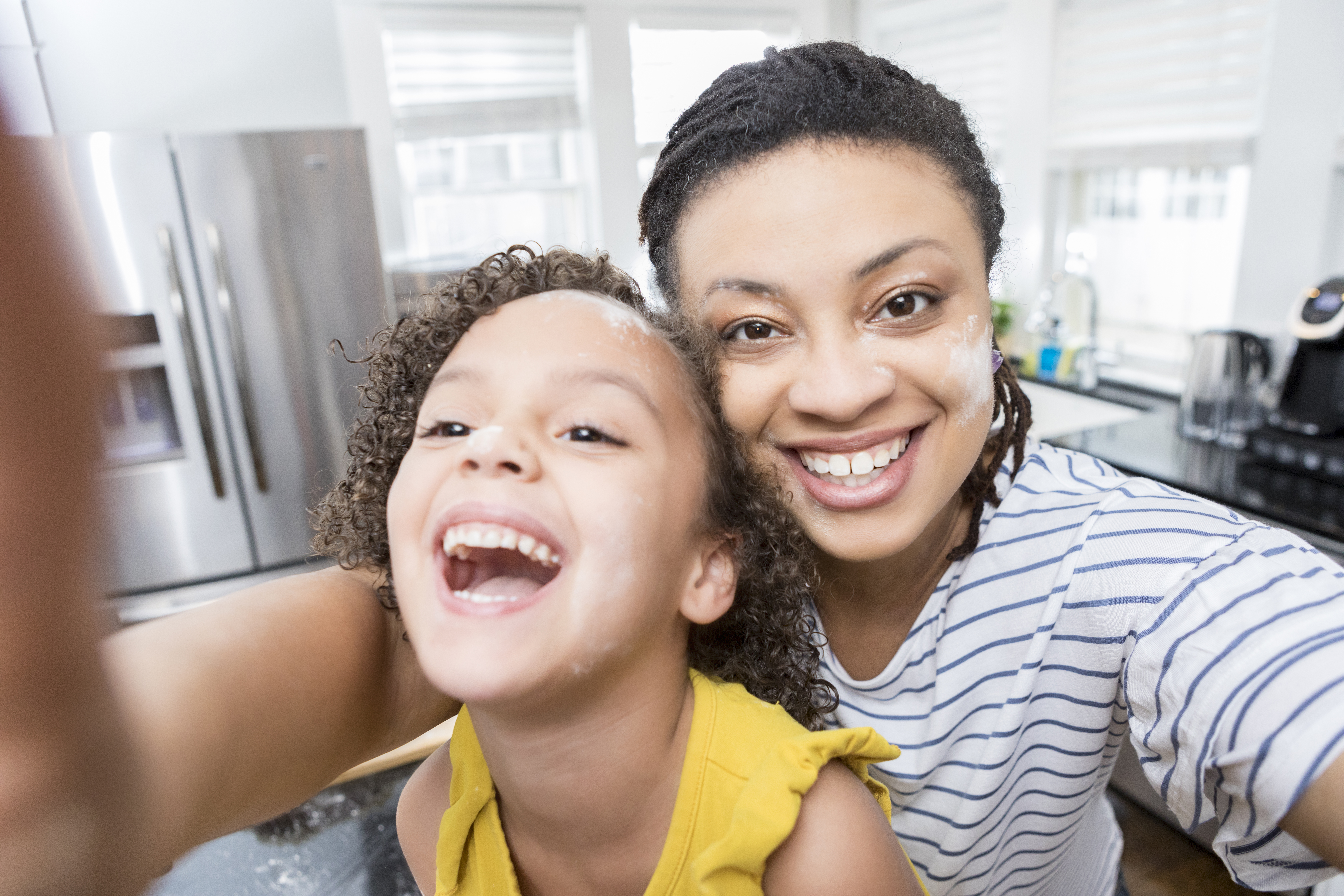 Mom and daughter take selfie at home