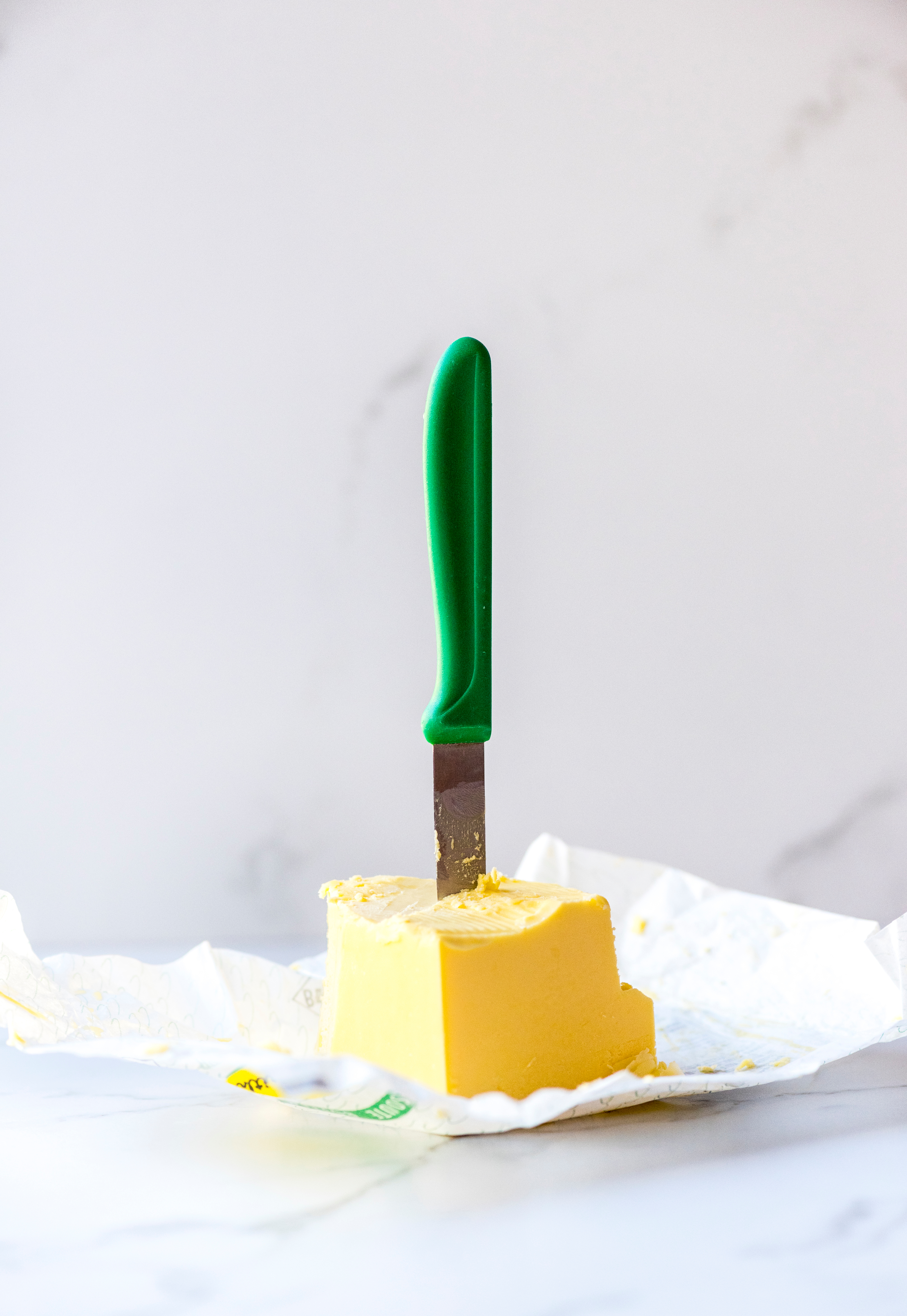 Close-Up Of Kitchen Knife In Butter On Table
