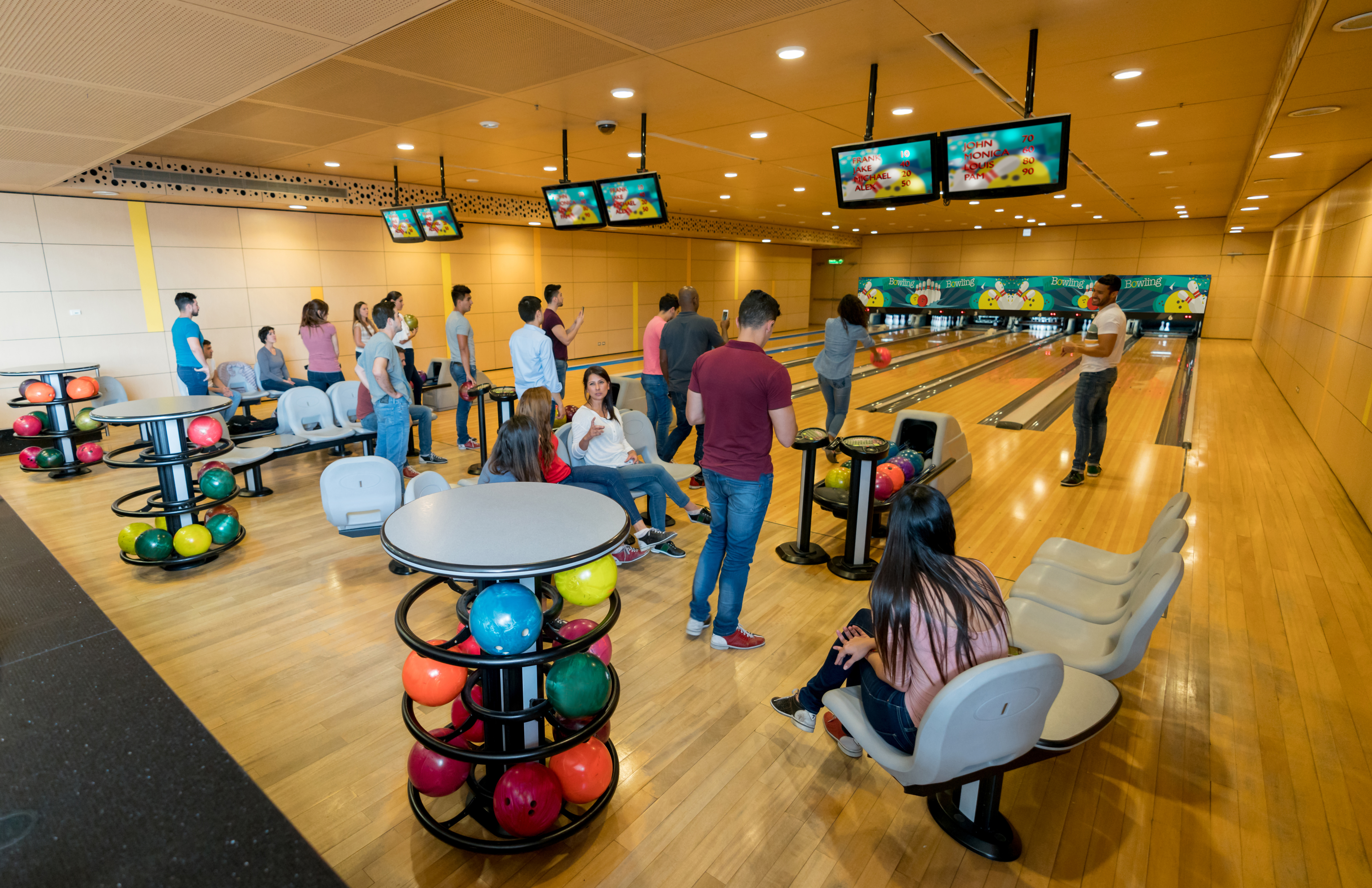 Group of people bowling with friends