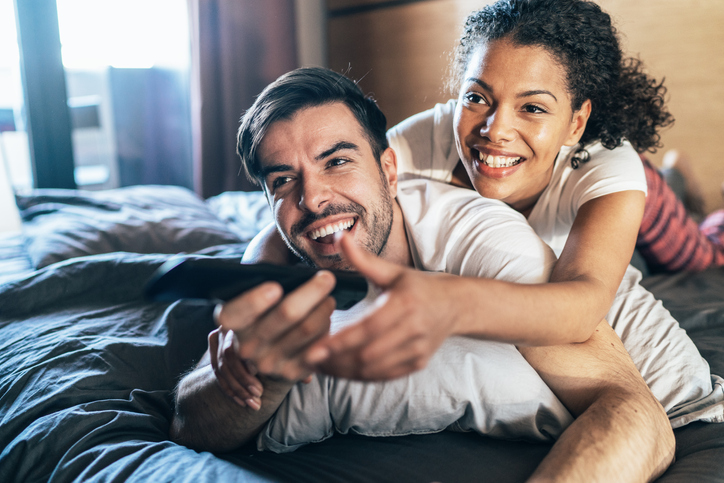 Happy couple watching tv