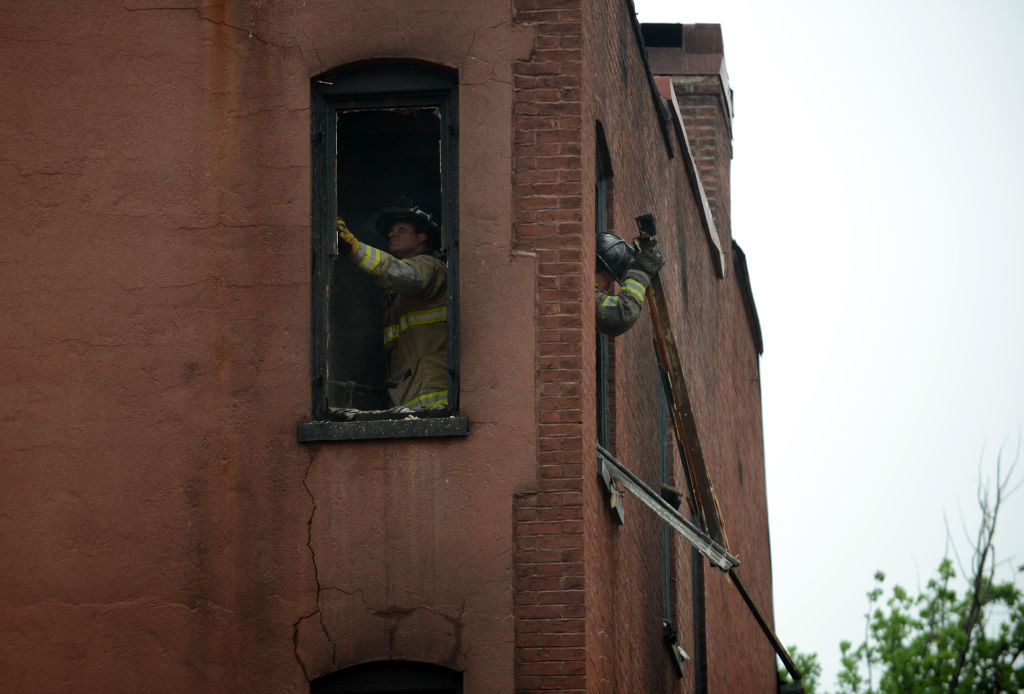 WASHINGTON, DC - JUNE 3: DC fire fighters clean out debris whil